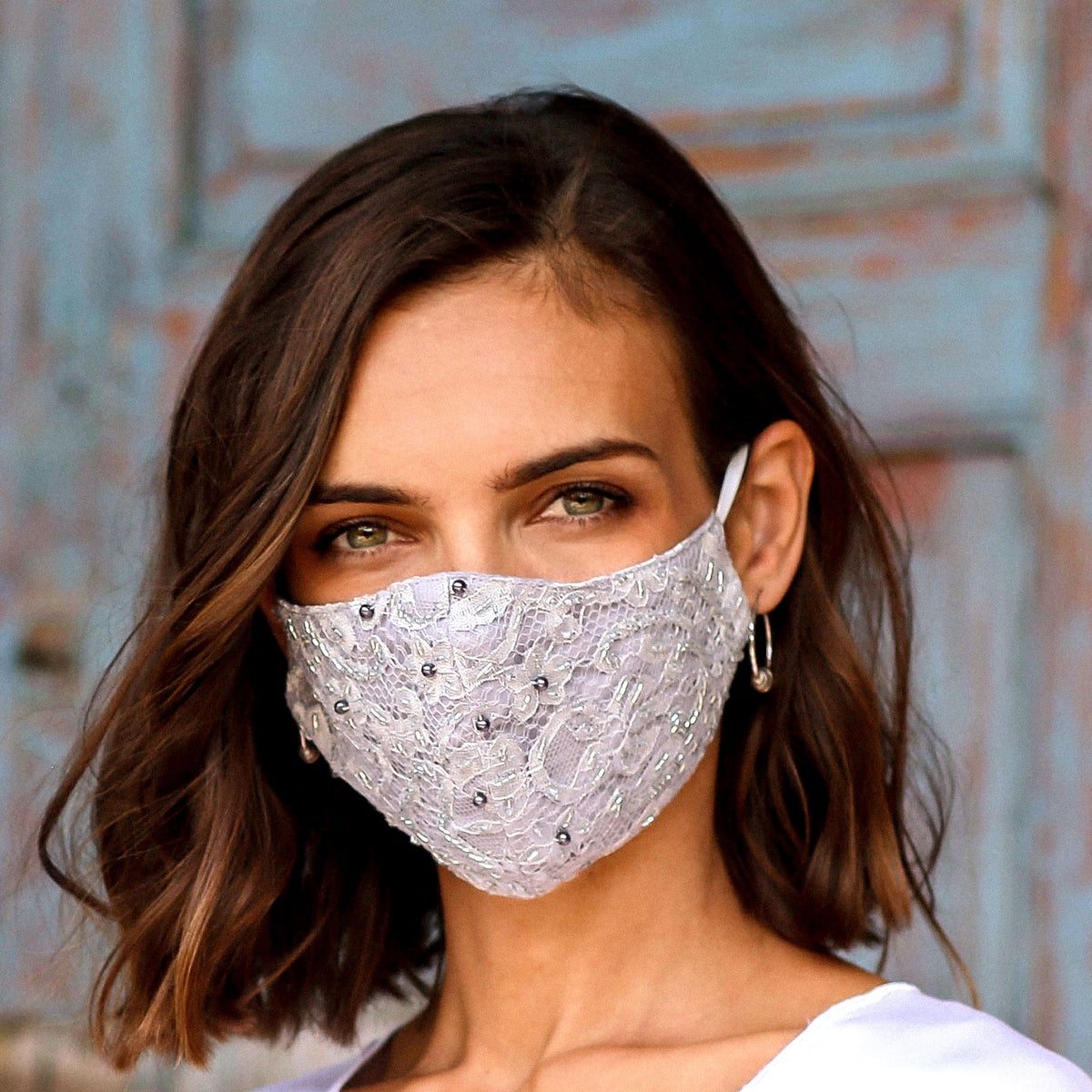 Woman wearing a Beaded Lace Balinese Face Mask in Neutral Grey