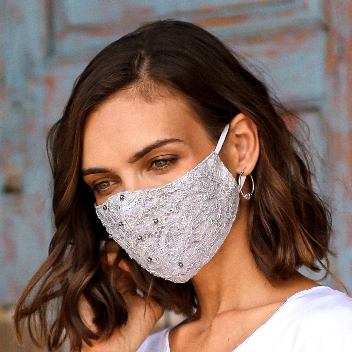 Woman wearing a Beaded Lace Balinese Face Mask in Neutral Grey