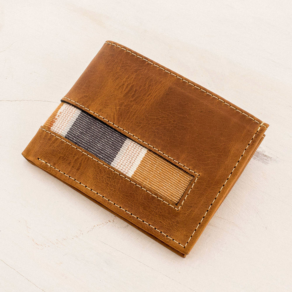 Crafted from supple brown leather with a slightly weathered finish - Bifold Wallet in Brown Leather and Cotton