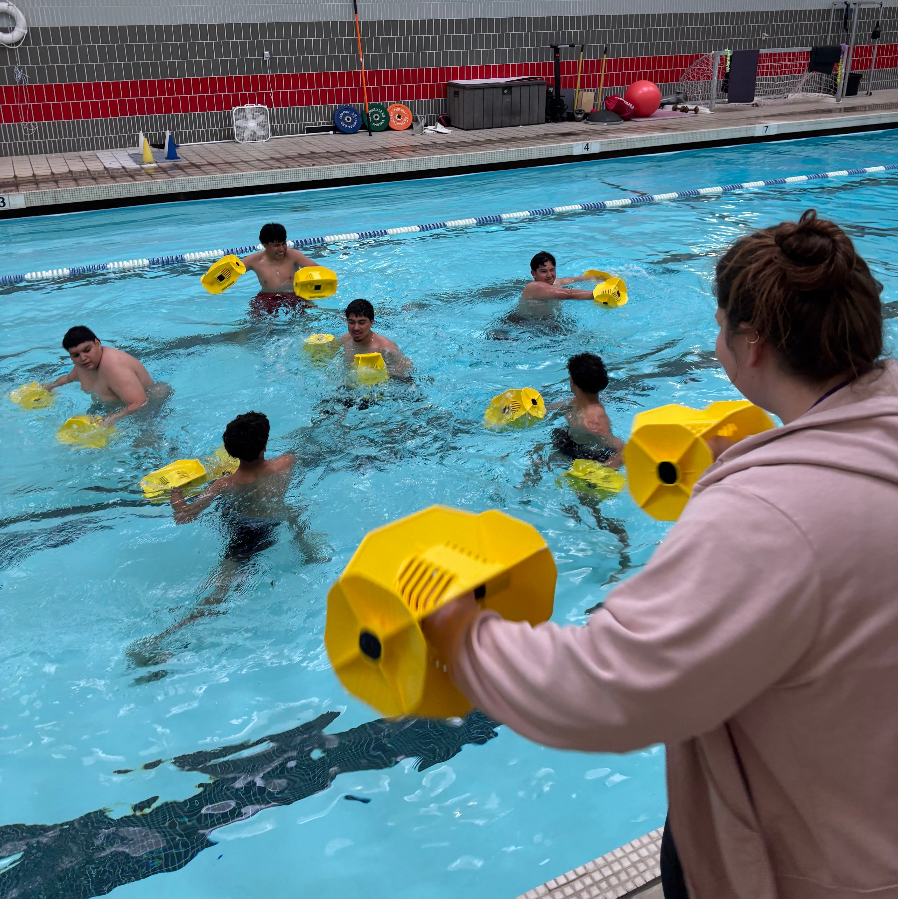 Young people in a pool with an instructor, representing hope and recovery through the Boys & Girls Club program for those impacted by the Los Angeles wildfires