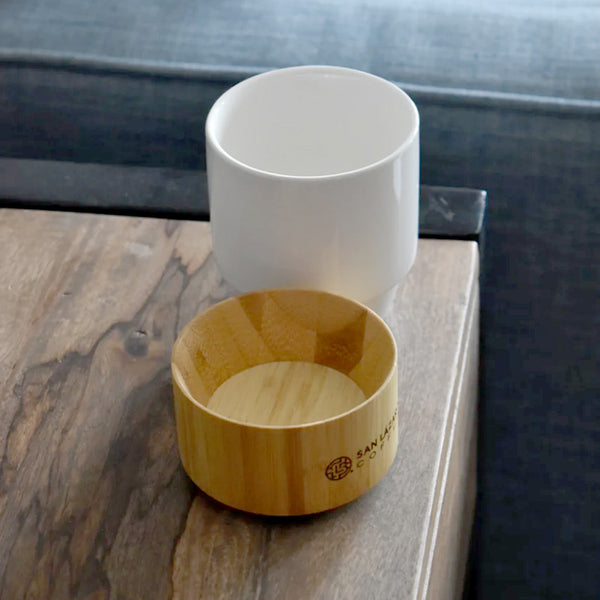 Ceramic coffee cup with a wooden holder