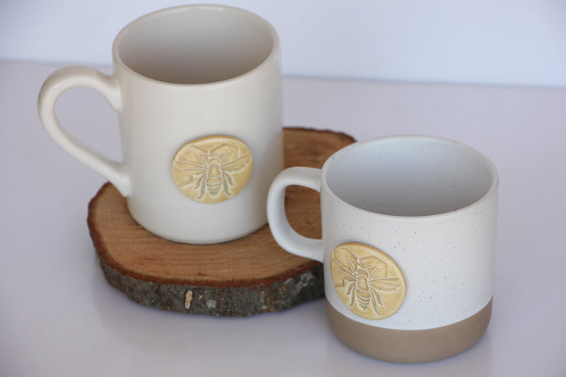 Mug sitting on wood log platter, with another mug placed next to it on the table