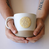 Mug in person's hands