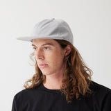 Light grey hat on model (side)