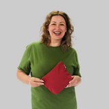 Model holding a sustainable red makeup bag