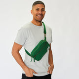 Male model wears sustainable organic cotton fanny pack styled as a shoulder sling bag