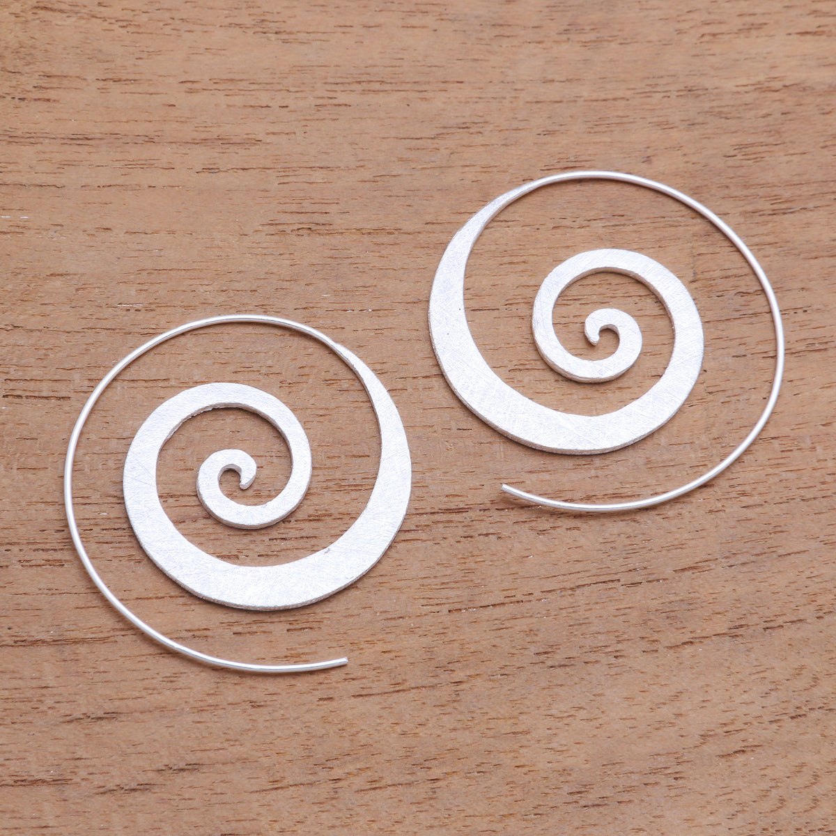 A Pair of Spiral-Shaped Half-Hoop Earrings in Silver
